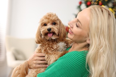 Woman with cute Maltipoo dog at home