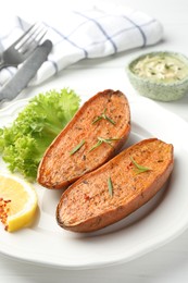 Tasty baked sweet potato served on white table, closeup