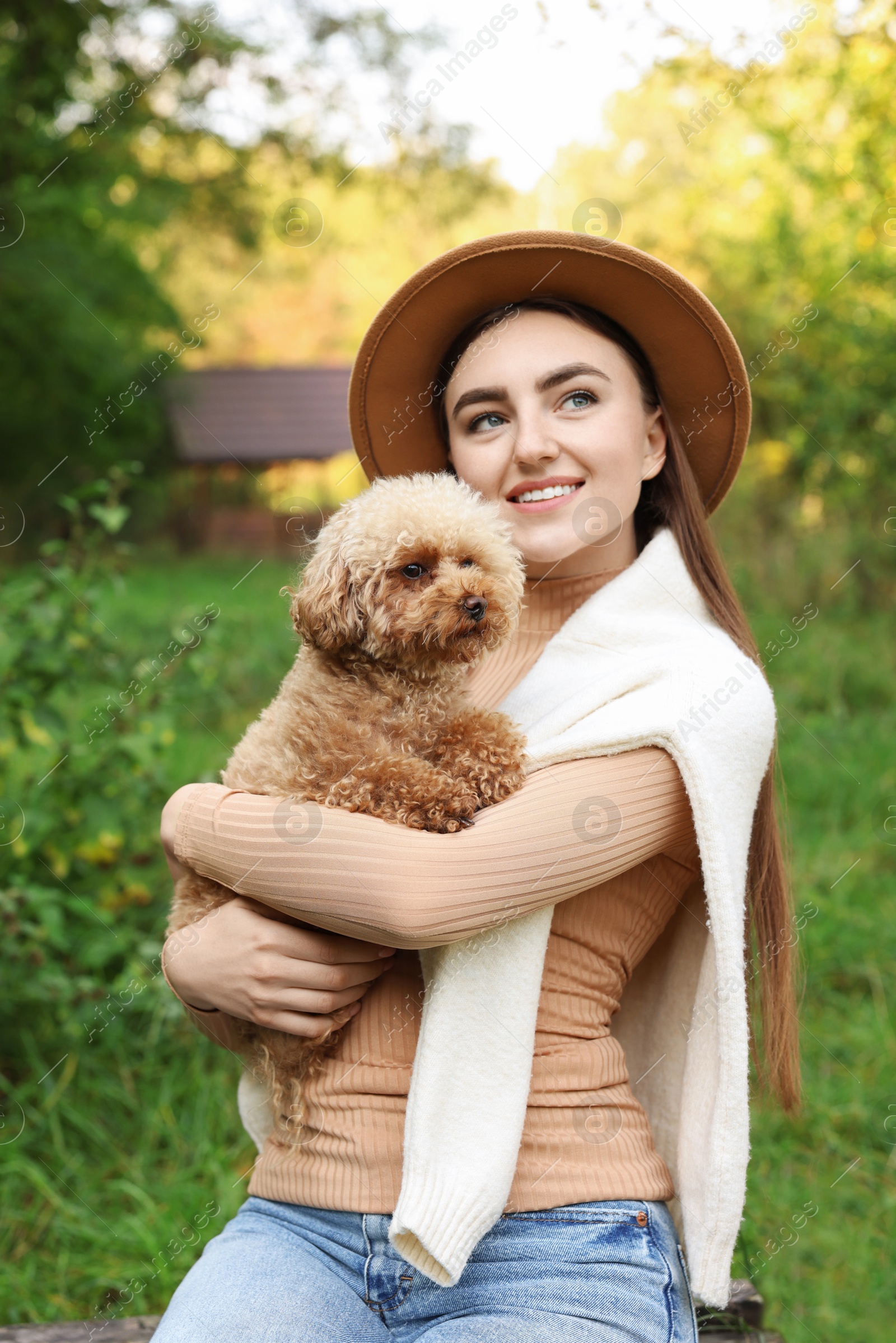 Photo of Smiling woman with her cute dog outdoors