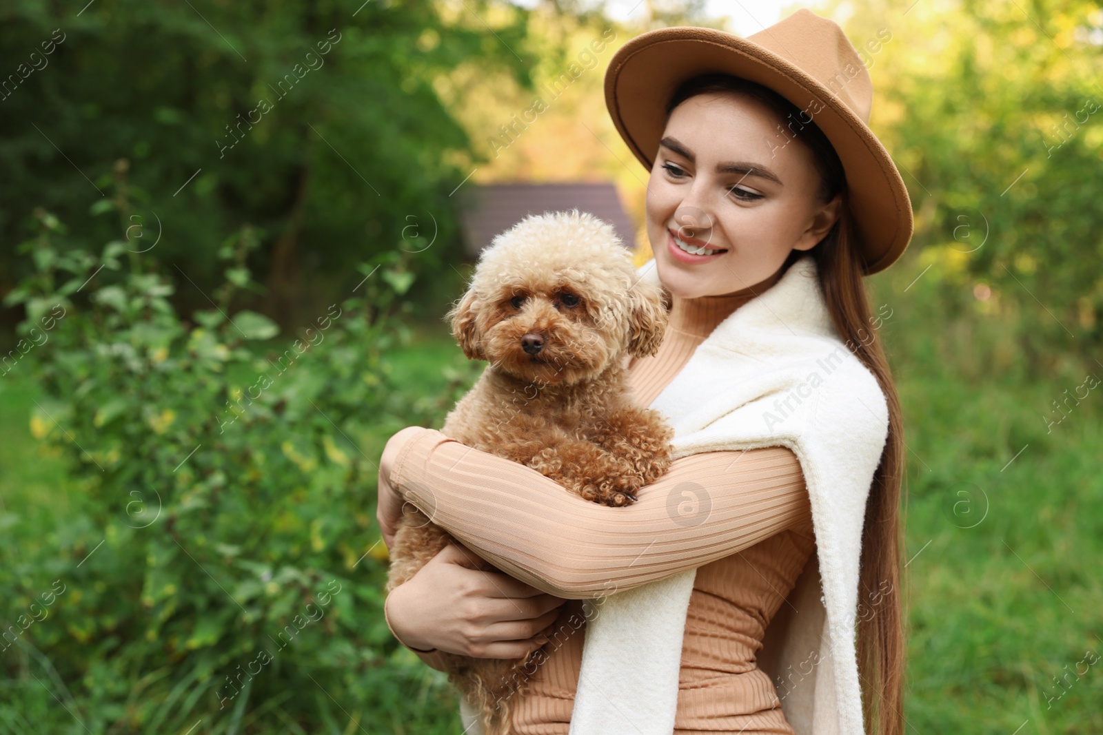 Photo of Smiling woman with cute dog outdoors. Space for text