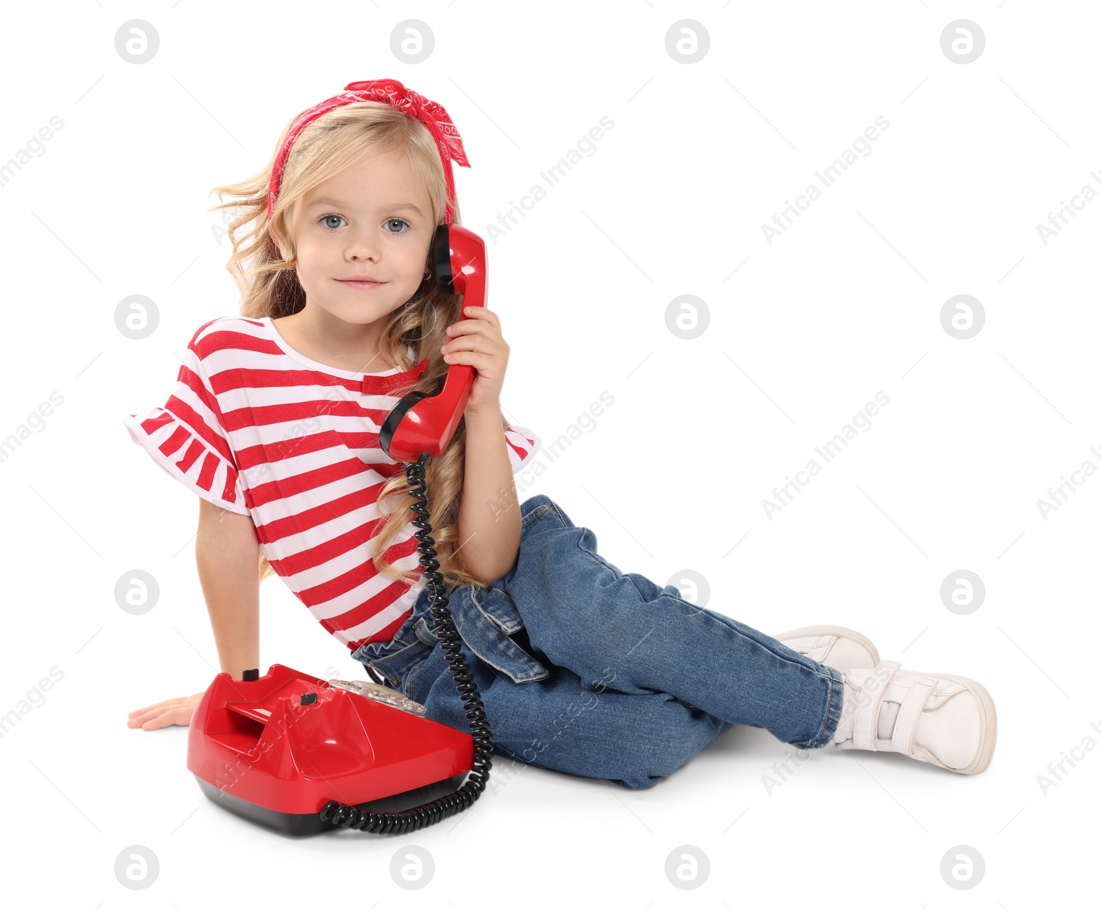 Photo of Cute little girl with telephone on white background