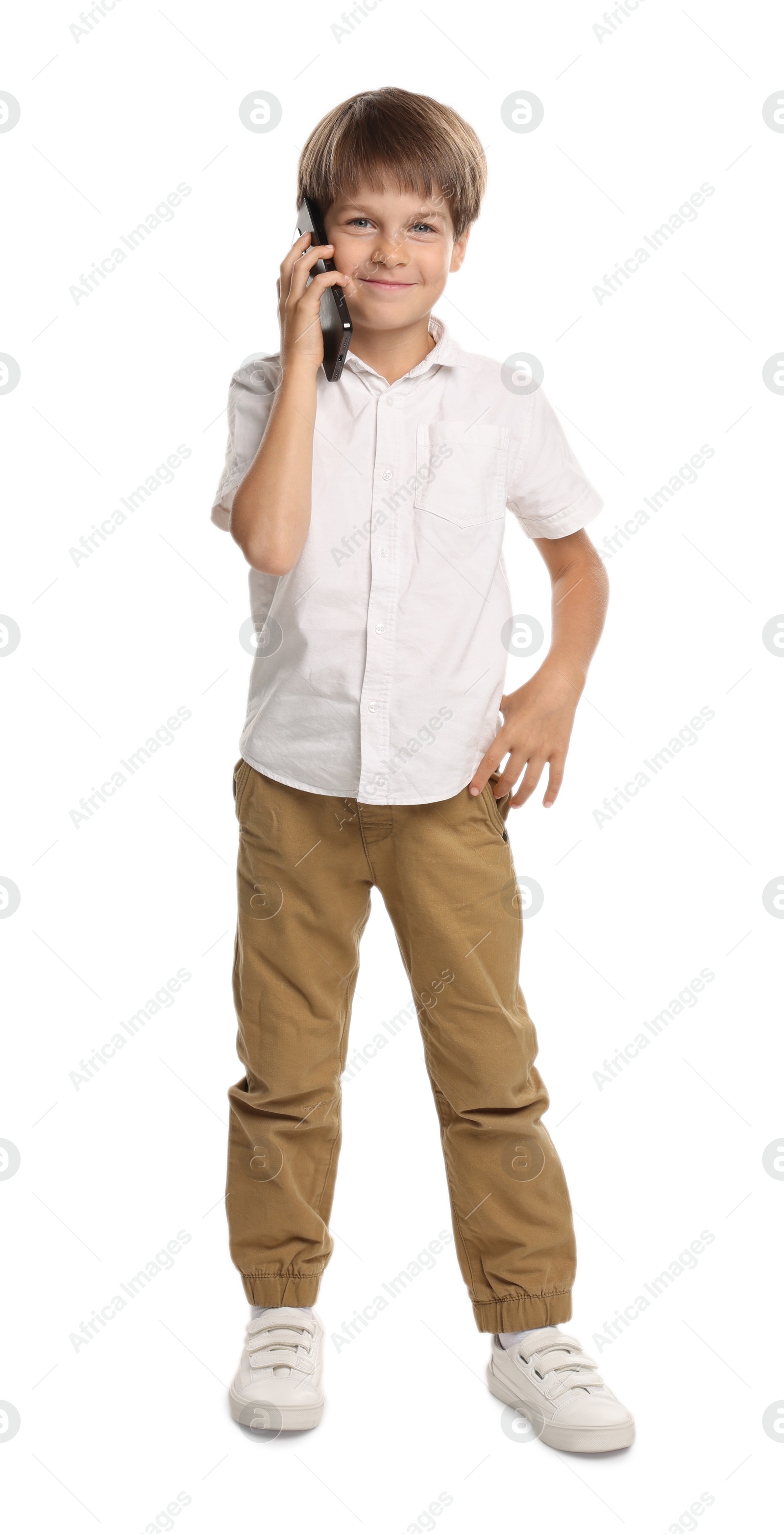 Photo of Cute little boy talking on smartphone against white background