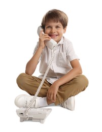 Cute little boy with telephone on white background