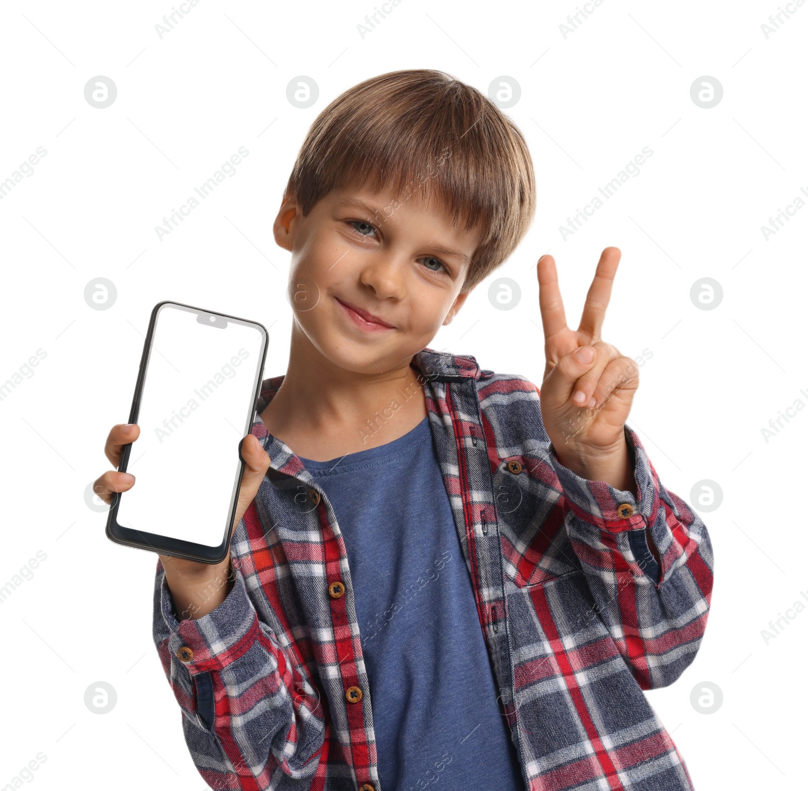 Photo of Cute little boy with smartphone showing peace sign on white background