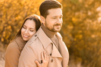 Photo of Lovely couple hugging in beautiful autumn park