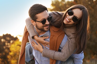 Beautiful couple having fun together in autumn park