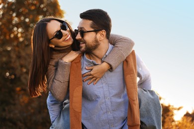 Beautiful couple having fun together in autumn park