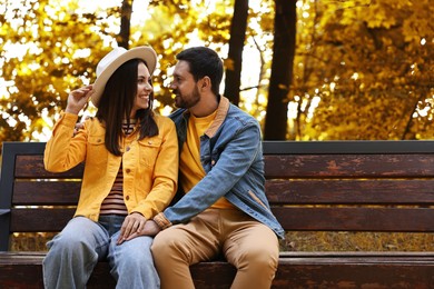 Beautiful couple spending time together in park on autumn day