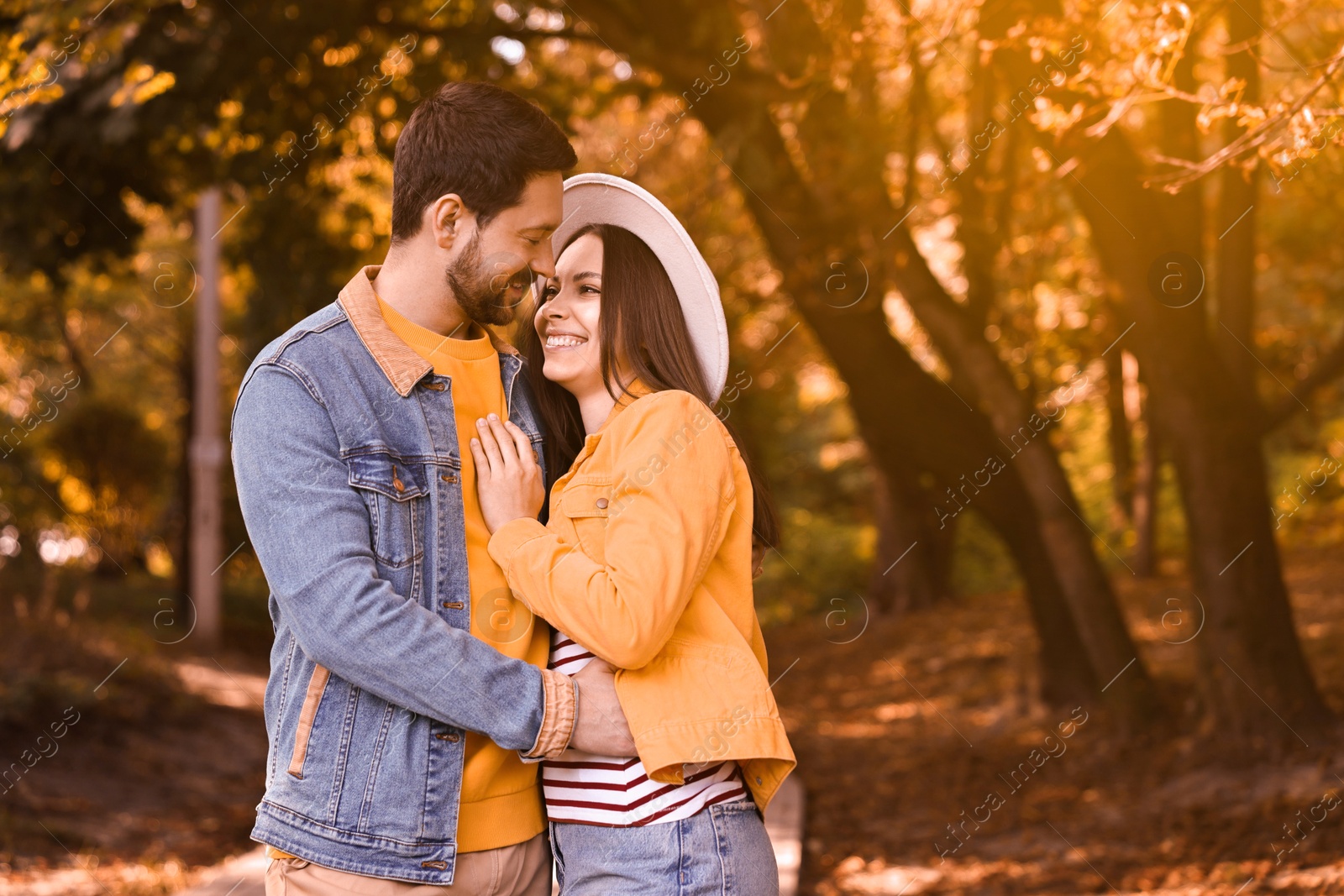 Photo of Beautiful couple hugging in park on autumn day