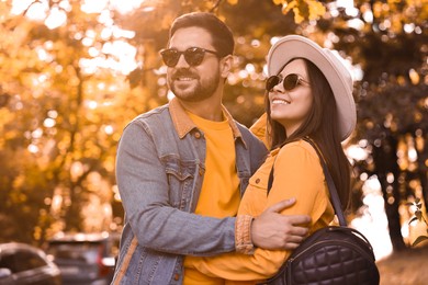 Photo of Beautiful couple hugging in park on autumn day