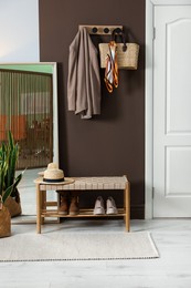 Photo of Stylish hallway interior with coat rack and mirror