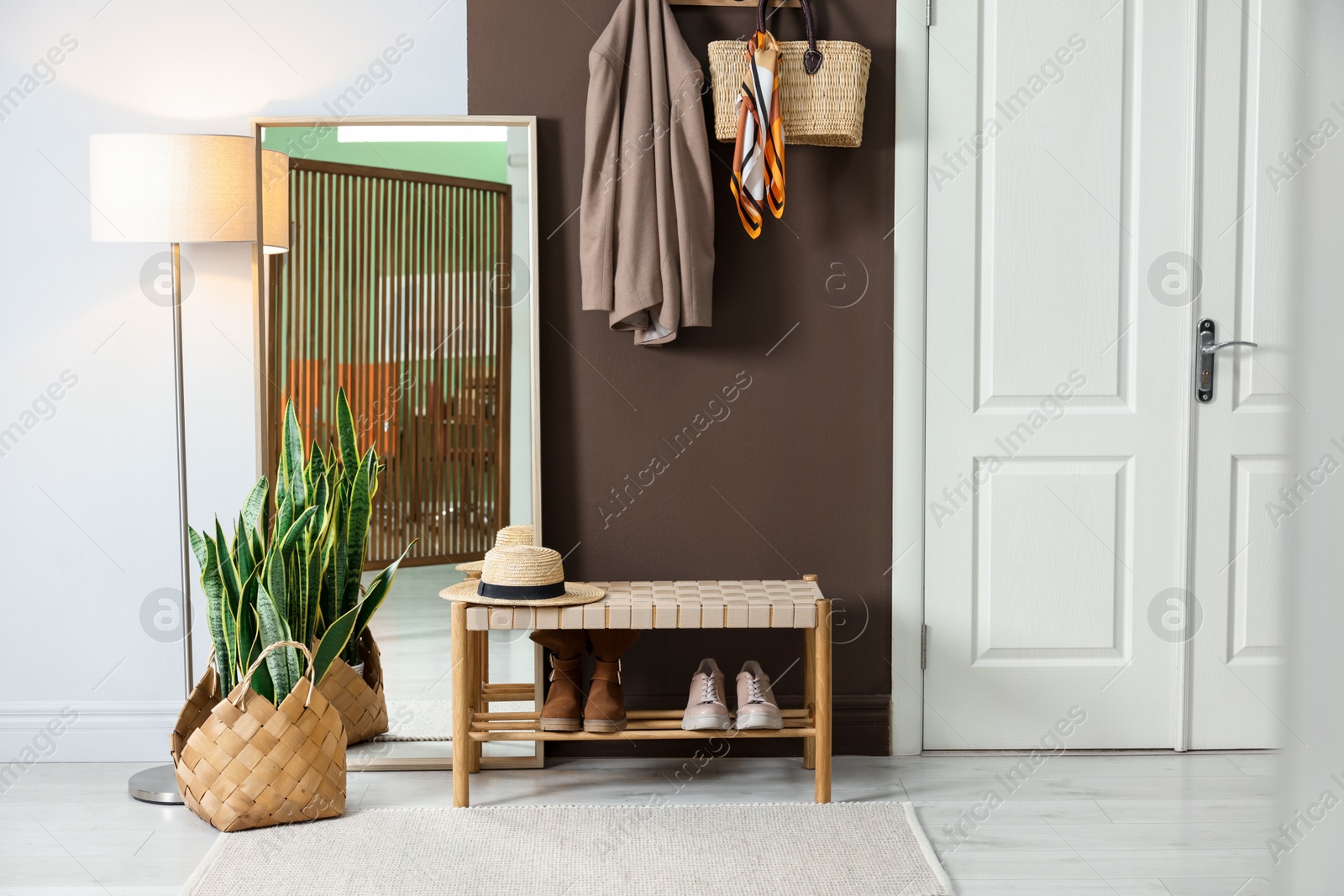 Photo of Stylish hallway interior with coat rack and mirror