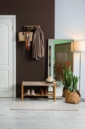 Photo of Stylish hallway interior with coat rack and mirror