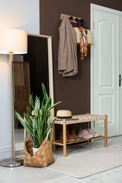 Photo of Stylish hallway interior with coat rack and mirror