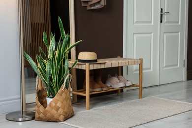 Photo of Stylish hallway interior with mirror and bench