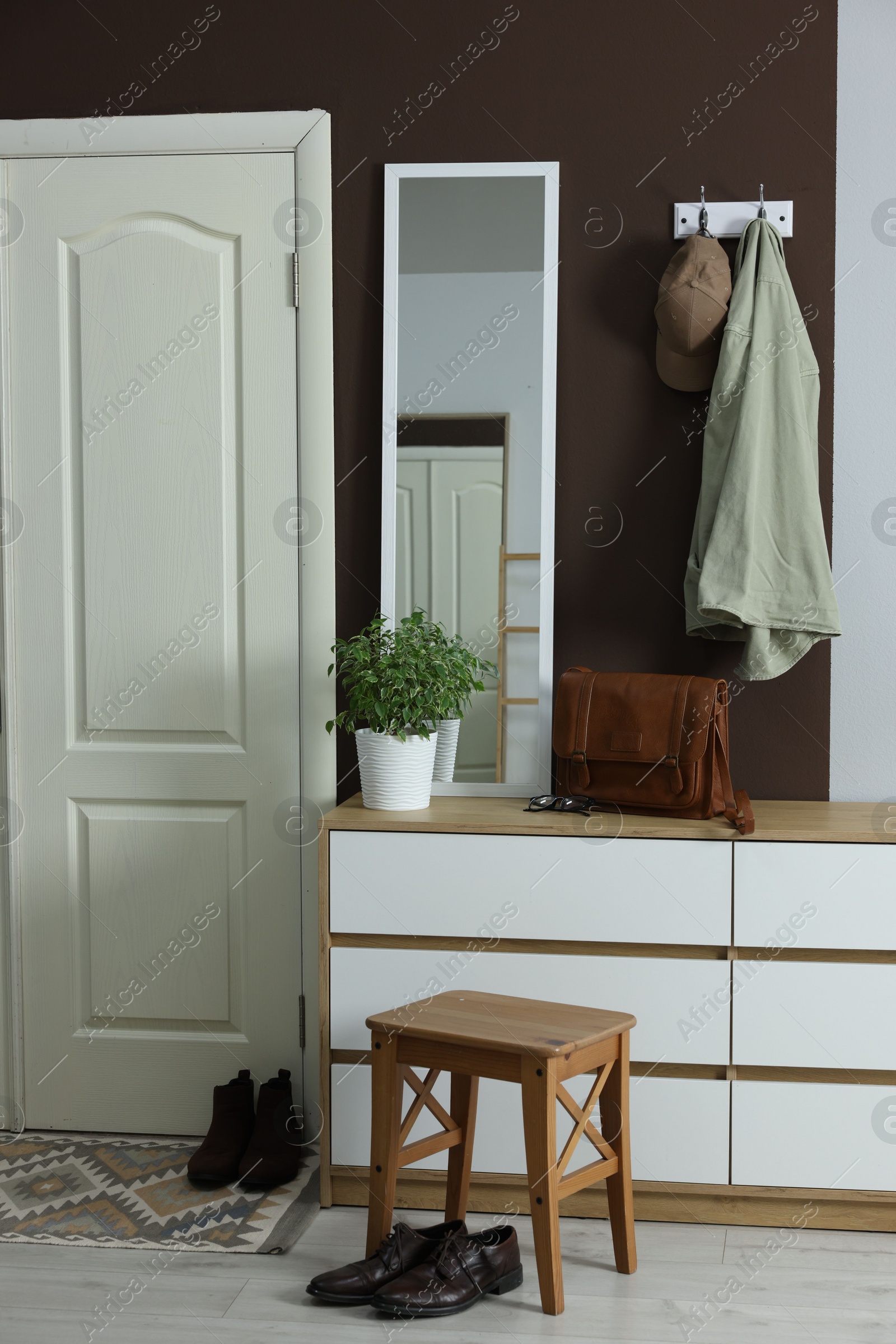 Photo of Stylish hallway interior with coat rack and mirror