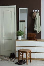 Photo of Stylish hallway interior with coat rack and mirror