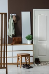 Stylish hallway interior with coat rack and mirror