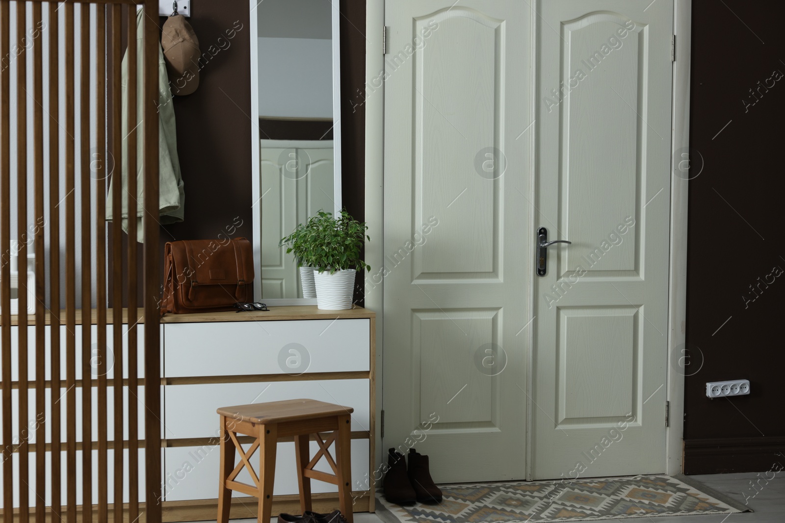 Photo of Stylish hallway interior with coat rack and mirror