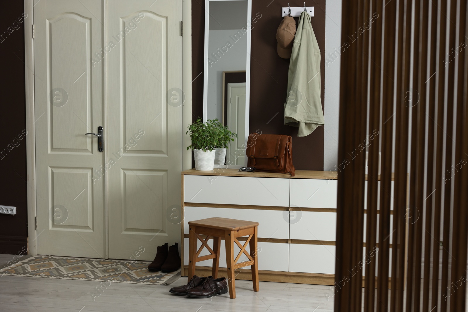 Photo of Stylish hallway interior with coat rack and mirror