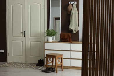 Photo of Stylish hallway interior with coat rack and mirror