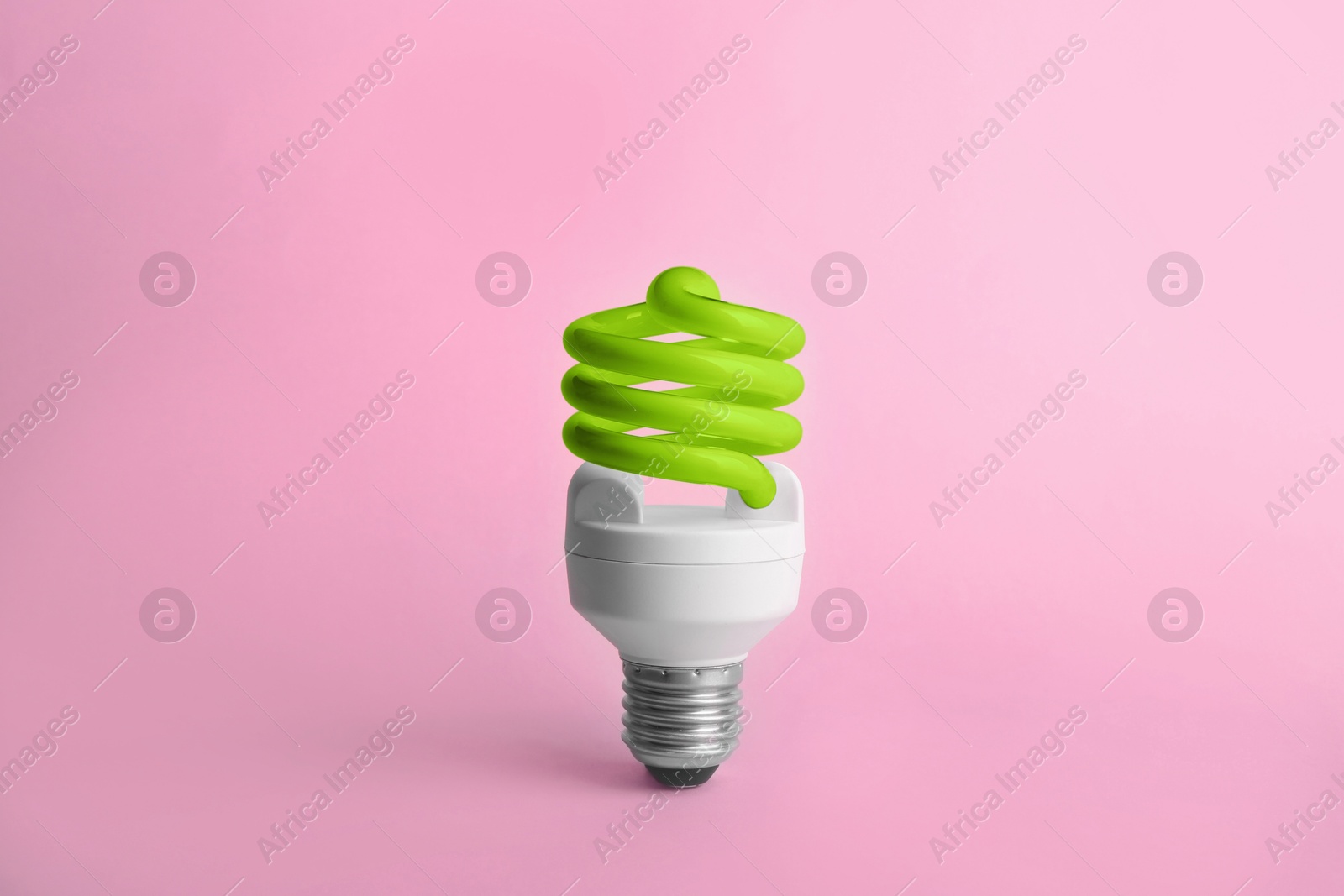 Image of Green fluorescent lamp bulb on pink background