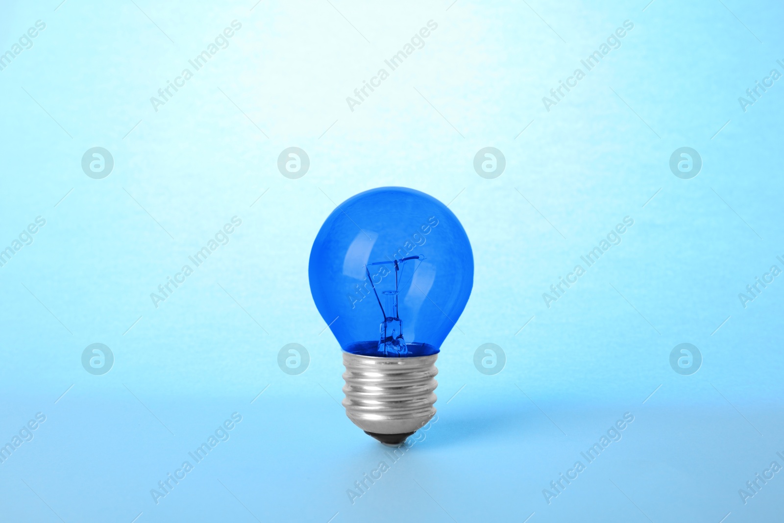 Image of One blue bulb on light blue background