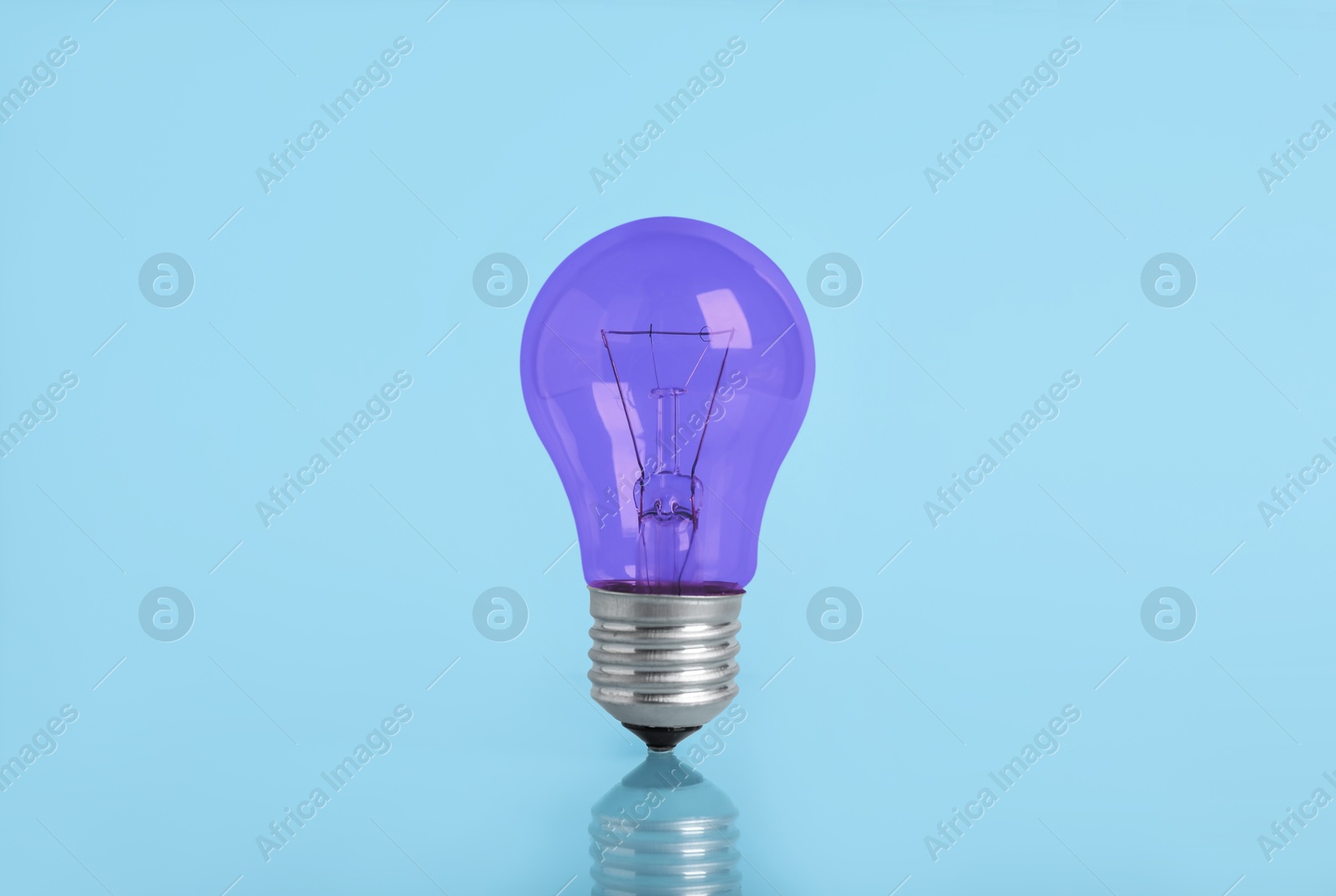 Image of One purple bulb on light blue background