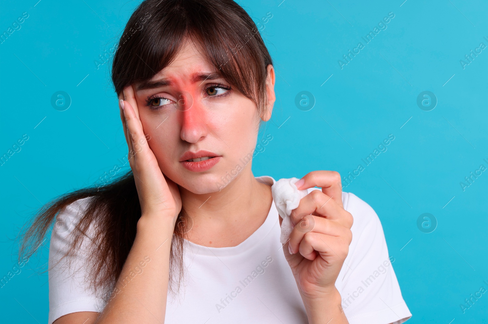 Image of Woman with tissue suffering from sinusitis on light blue background