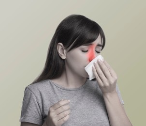 Woman with tissue suffering from sinusitis, color toned with red color accent