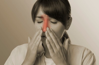 Image of Woman suffering from sinusitis, color toned with red color accent