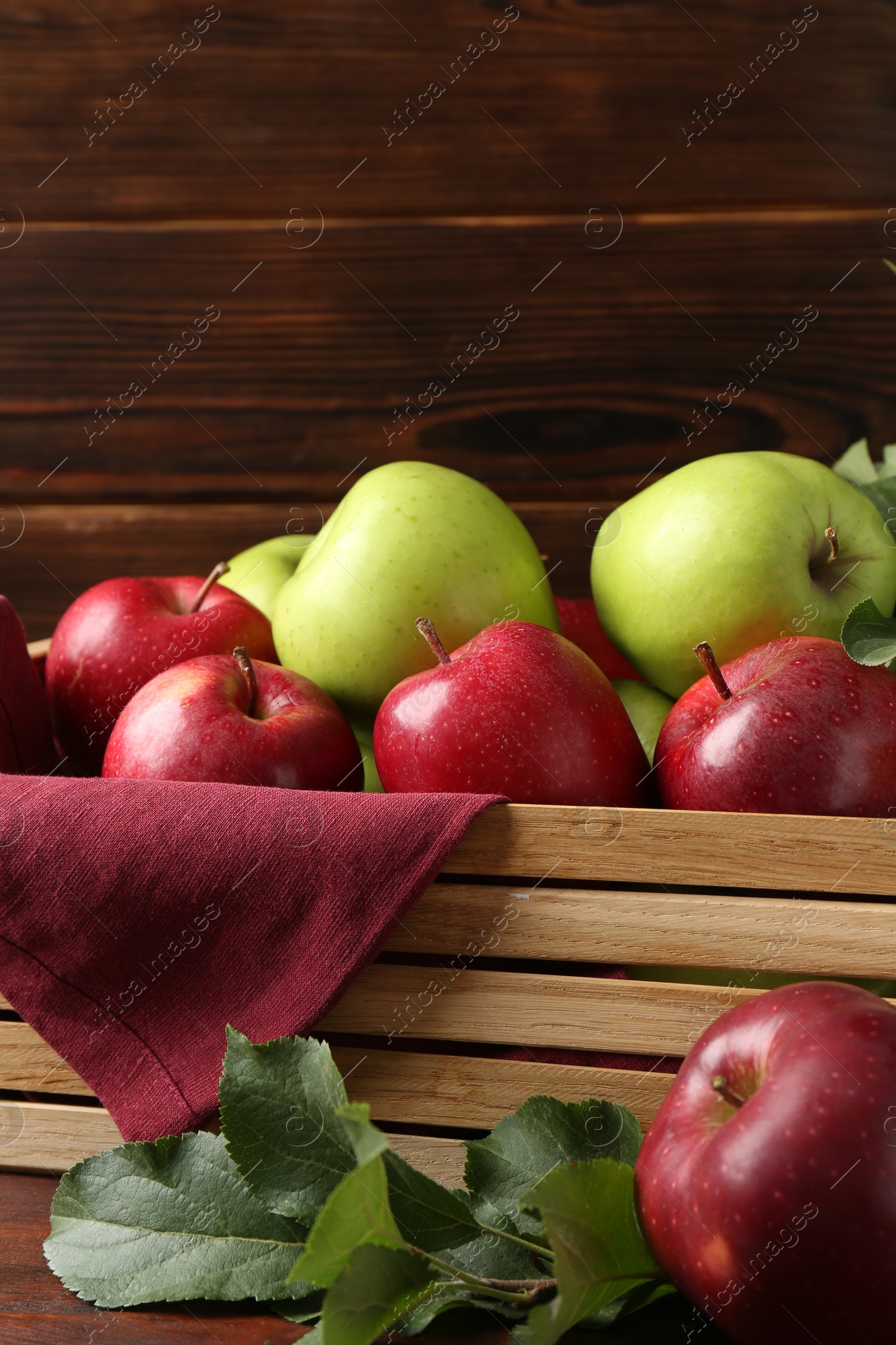 Ripe red and green apples in crate on table, closeup Photo of Ripe red and green apples in crate on table, closeup