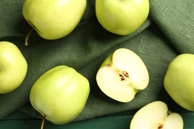 Photo of Ripe apples on green wooden table, top view