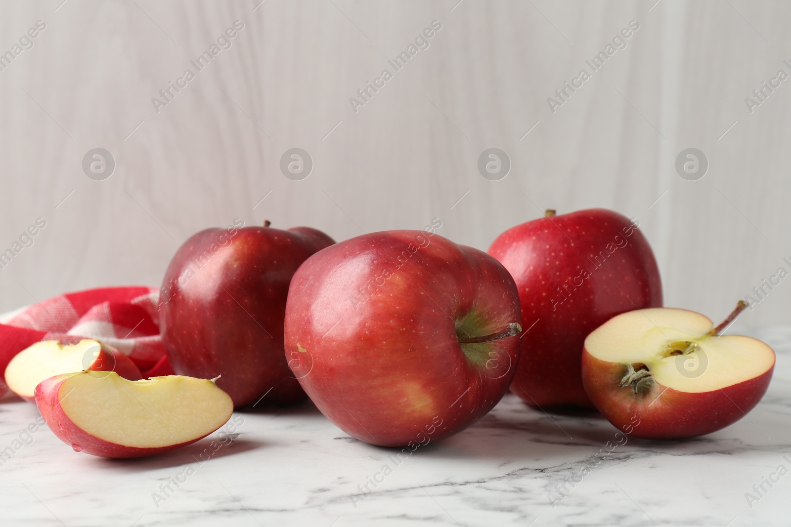 Photo of Ripe red apples on white marble table