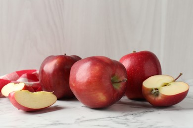 Photo of Ripe red apples on white marble table