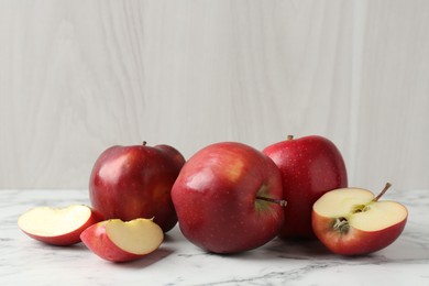 Photo of Ripe red apples on white marble table