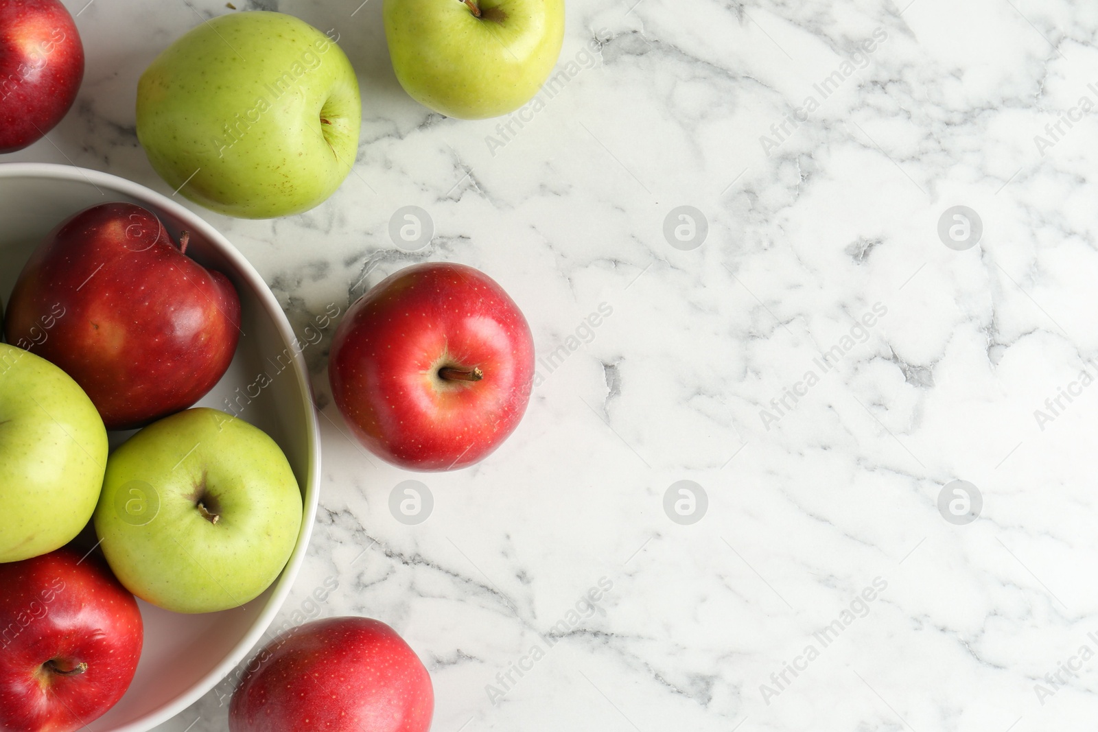 Ripe red and green apples on white marble table, top view. Space for text Photo of Ripe red and green apples on white marble table, top view. Space for text