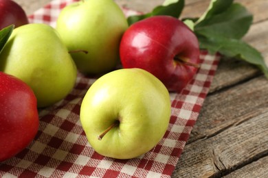 Photo of Ripe red and green apples on wooden table, closeup