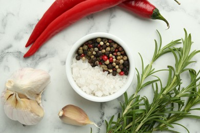 Sea salt, peppercorns, rosemary, chili peppers and garlic on white marble table, top view