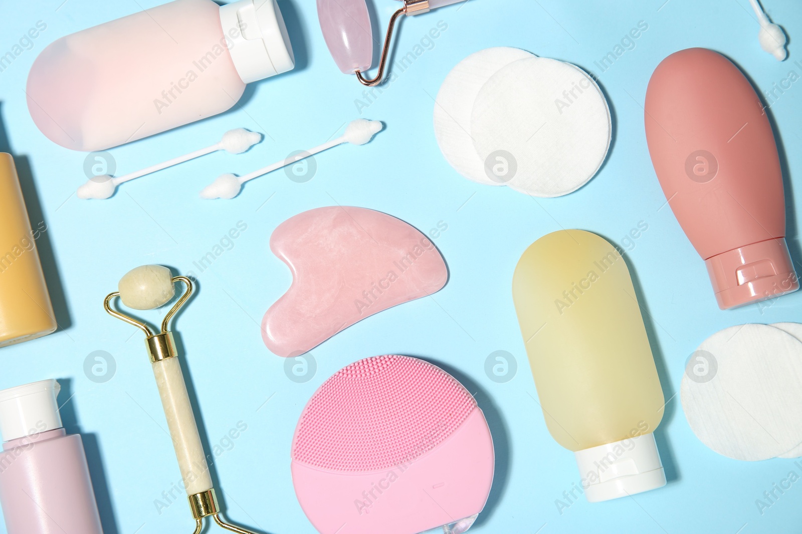 Photo of Different skin care products on light blue background, flat lay