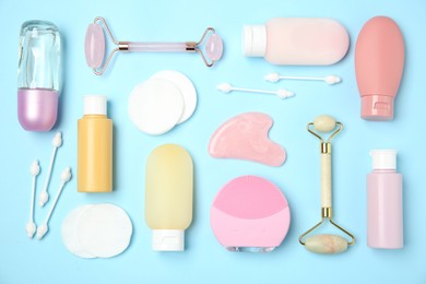 Different body care products on light blue background, flat lay