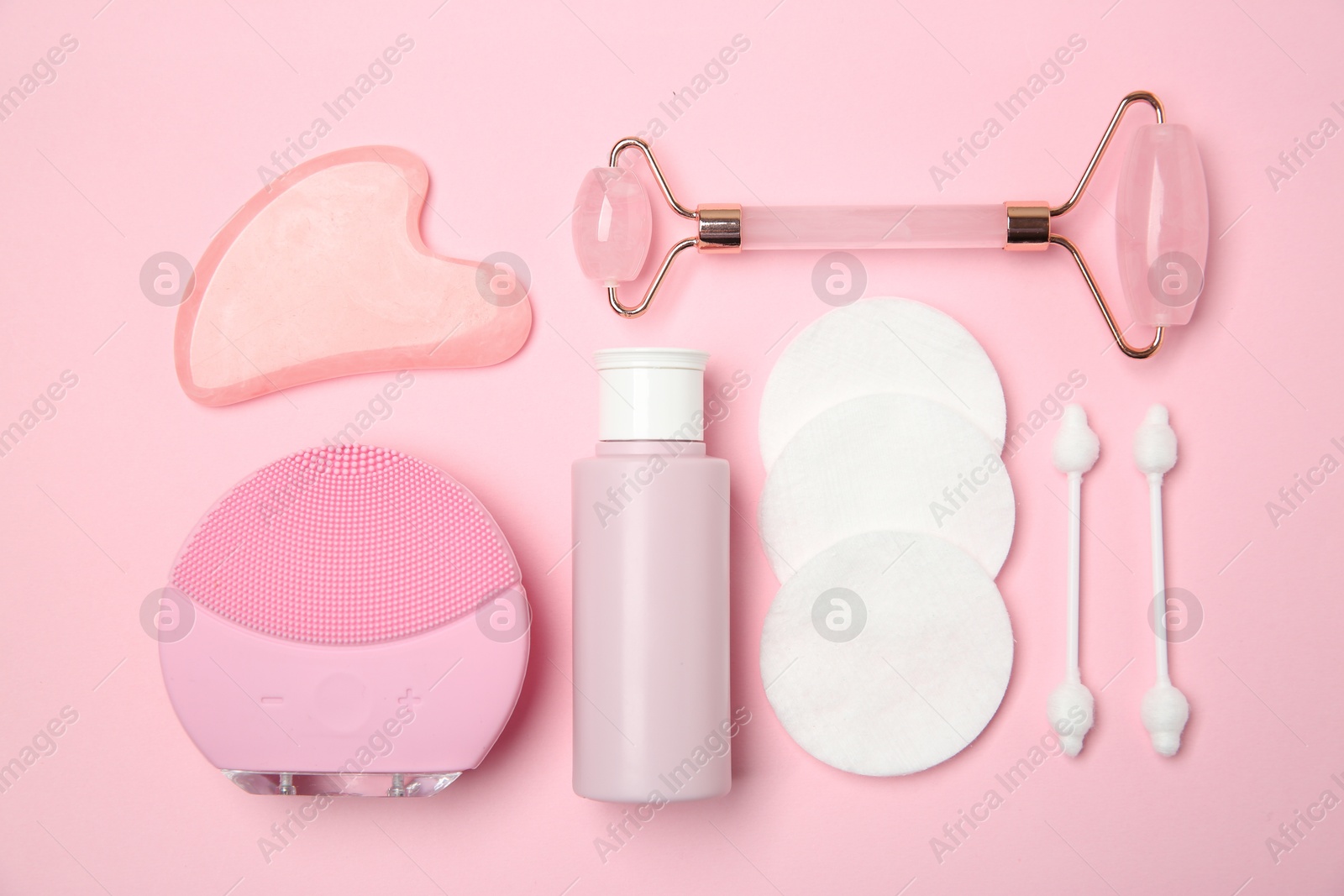 Photo of Different skin care products on pink background, flat lay