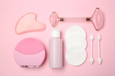 Different skin care products on pink background, flat lay