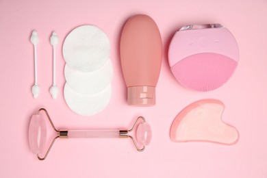 Different skin care products on pink background, flat lay