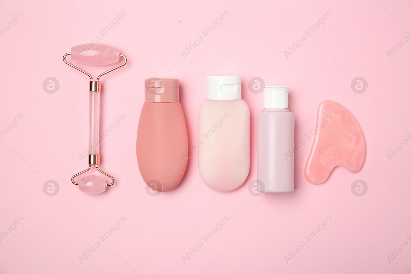 Photo of Different skin care products on pink background, flat lay