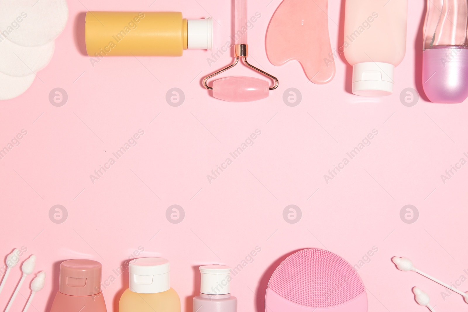 Photo of Different body care products on pink background, flat lay. Space for text