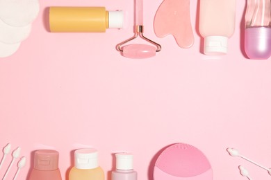 Photo of Different body care products on pink background, flat lay. Space for text