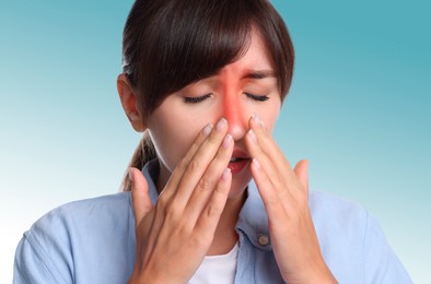 Woman suffering from sinusitis on gradient background