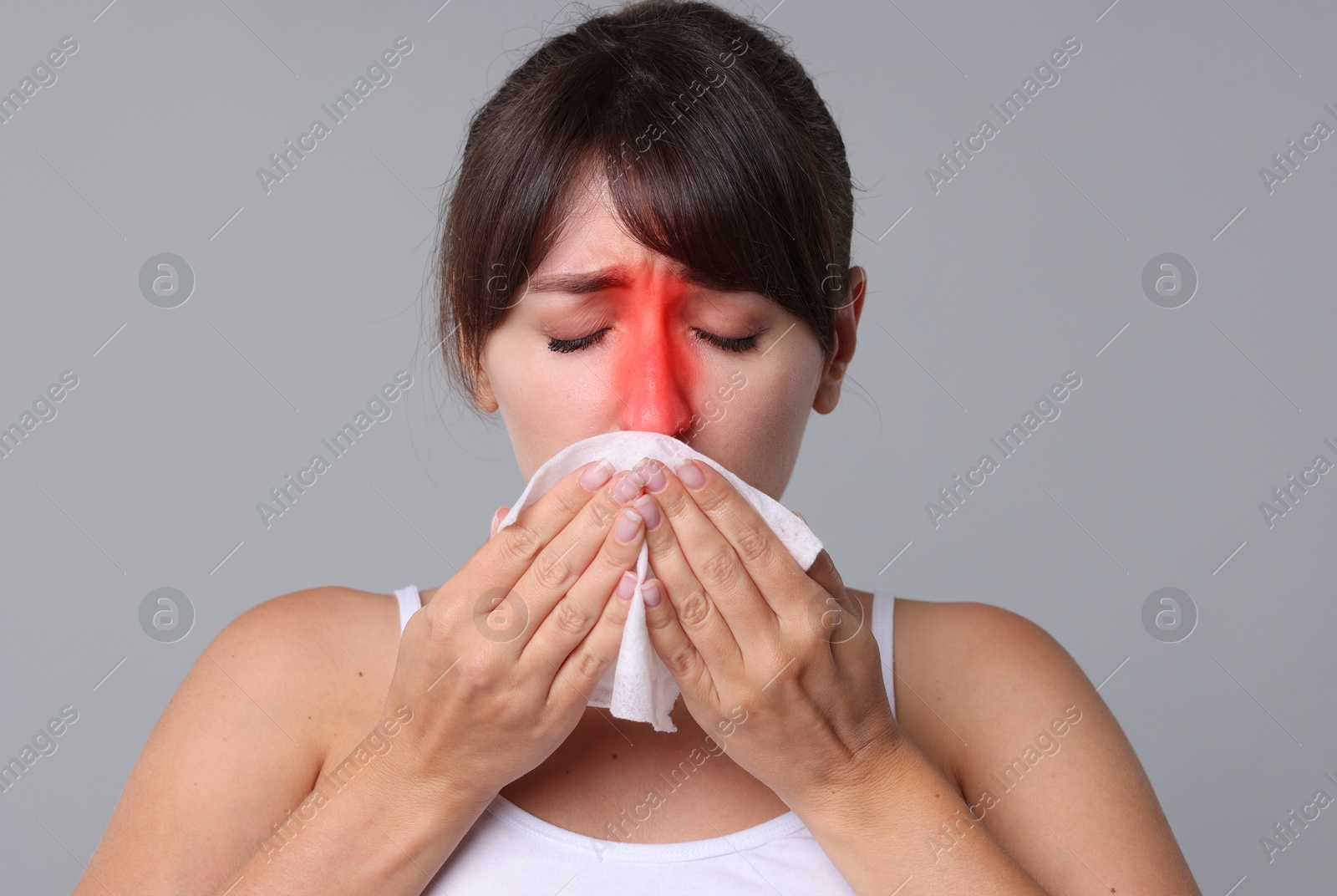 Image of Woman with tissue suffering from sinusitis on grey background