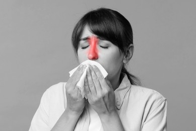 Woman with tissue suffering from sinusitis. Black and white effect with red color accent